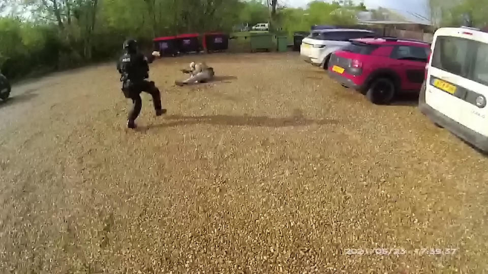 This is the dramatic moment a firearms police officer skillfully took down a suicidal paedophile armed with an imitation machine gun in Surlingham, Norfolk. See SWNS copy SWCAgun:  The quick-thinking cop shot Simon Tait, 38, in the leg with a rubber bullet after he pointed his fake M16 assault rifle straight at the officer.  Tait - who was found to have 1,000 child porn images in a separate offence - had earlier stormed into his local pub dressed in combat gear on Sunday, May 23. 