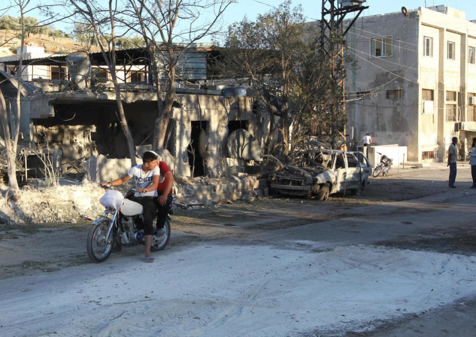 <p>People inspect the damage as they stand near a Save the Children sponsored maternity hospital after an airstrike in the rebel-controlled town of Kafer Takhareem in Idlib province, Syria July 29, 2016. (Photo: Ammar Abdullah/Reuters)</p>