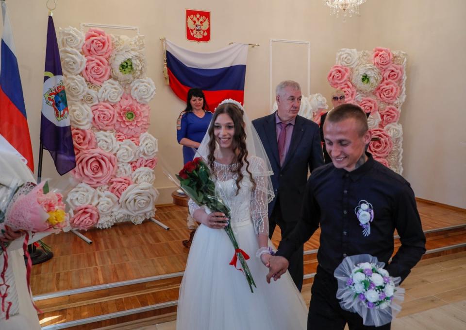 A picture taken during a visit to Mariupol organised by the Russian military shows the acting mayor of Berdyansk, Alexander Saulenko (centre) attending the register of marriages in the city’s wedding palace (EPA)