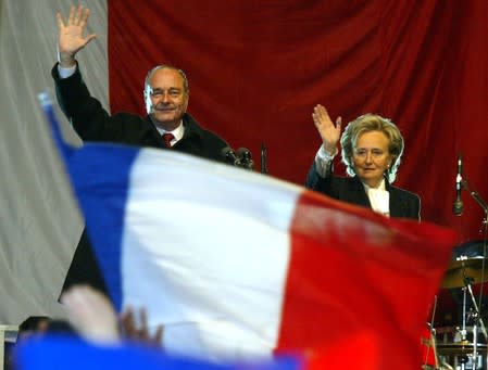 FILE PHOTO: File photo of French President Jacques Chirac and his wife Bernadette saluting crowds at a victory rally in Paris