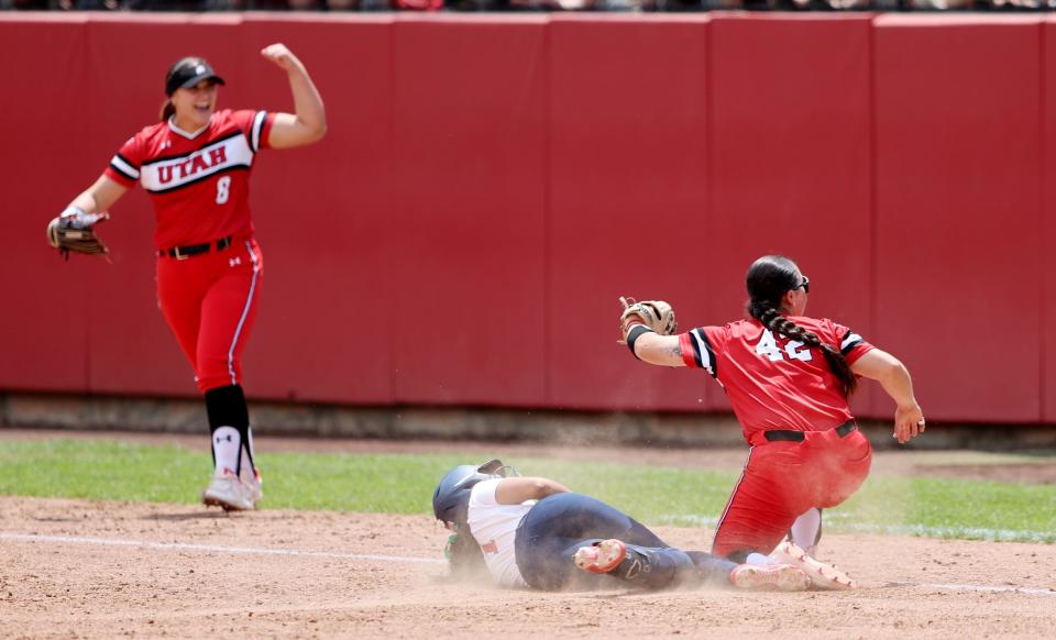 Pitcher Mariah Lopez, celebrates as teammate Julia Jimenez looks up at for verification on the tag out of Ole Miss’ Jalia Lassiter, at third base as they play in the NCAA softball regional championship at Utah in Salt Lake City on Sunday, May 21, 2023. Utah won 4-1. | Scott G Winterton, Deseret News