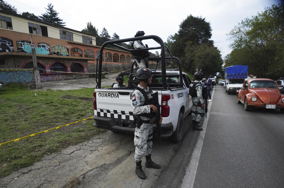 National Guardsmen guard the place where a confrontation took place with what authorities say were groups of criminals, that left several police officers wounded and more than a dozen people detained, in Tupilejo, on the outskirts of Mexico City, on Tuesday, March 12. July 2022. (AP Photo/ Marco Ugarte)