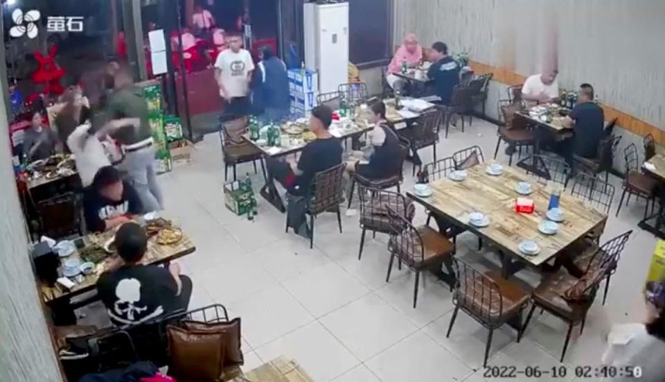 A man assaults a woman at a restaurant in the northeastern city of Tangshan, China (via REUTERS)