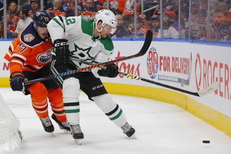 Nov 27, 2018; Edmonton, Alberta, CAN; Edmonton Oilers defensemen Oscar Klefbom (77) battles for a loose puck with Dallas Stars forward Radek Faksa (12) during the second period at Rogers Place. Mandatory Credit: Perry Nelson-USA TODAY Sports