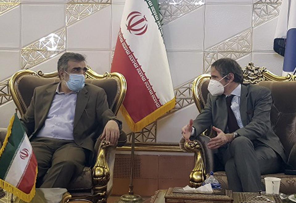 FILE - In this Feb. 20, 2021, file photo, Director General of International Atomic Energy Agency, IAEA, Rafael Mariano Grossi, right, speaks with spokesman of Iran's atomic agency Behrouz Kamalvandi upon his arrival at Tehran's Imam Khomeini airport, Iran. Iran has said it plans to cease its implementation of the "Additional Protocol," a confidential agreement between Tehran and the IAEA reached as part of the landmark nuclear accord that grants the U.N. inspectors enhanced powers to visit nuclear facilities and watch Iran's program. (Atomic Energy Organization of Iran via AP, File)