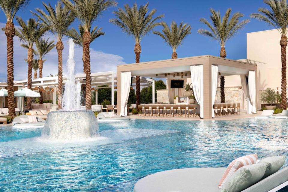 a pool with a gazebo and a fountain in it