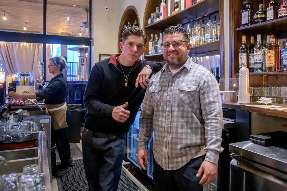 Armando Velazquez, right, owner of Verandah Cocina Latina, and his son Isaac Velazquez, general manager, pose behind the bar at the new Latin-themed restaurant at at 120 W. Jefferson Street in Morton.