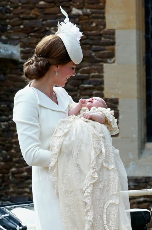 Britain's Catherine, Duchess of Cambridge, carries her daughter, Princess Charlotte of Cambridge at St. Mary Magdalene Church in Sandringham, England, on July 5, 2015