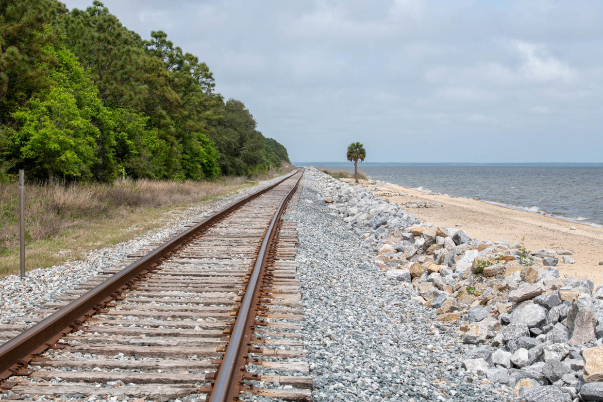 The shoreline and railroad tracks parallel to the boardwalk at Bay Bluffs Park in Pensacola on Wednesday, April 5, 2023.  Bluffline Inc. is a new non-profit aiming to coordinate between local governments and landowners for the construction a new walkway and greenway from Pensacola Bluffs Bay Park to downtown Pensacola’s Bruce Beach and then to the Jackson Lakes property on the western side of Bayou Chico.