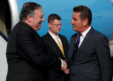 U.S. Secretary of State Mike Pompeo greets Deputy Governor of Ankara Murat Soylu as he arrives in Ankara, Turkey, October 17, 2018. REUTERS/Leah Millis/Pool