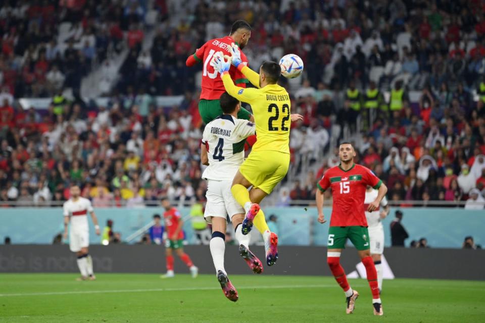 En-Nesyri of Morocco rises above goalkeeper Diogo Costa and Ruben Dias of Portugal to head in the winner (Getty Images)