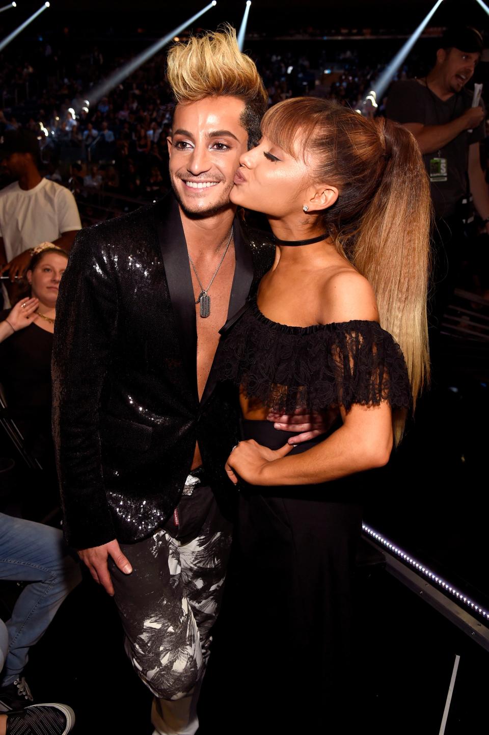 Ariana kissing Frankie on the cheek.