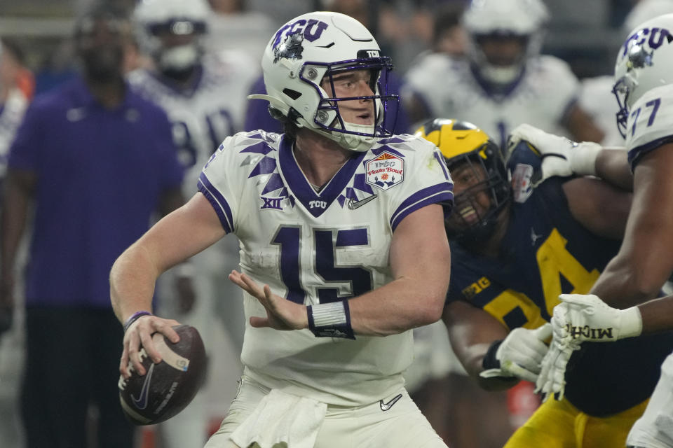 TCU quarterback Max Duggan (15) looks to pass against Michigan during the first half of the Fiesta Bowl NCAA college football semifinal playoff game, Saturday, Dec. 31, 2022, in Glendale, Ariz. (AP Photo/Rick Scuteri)