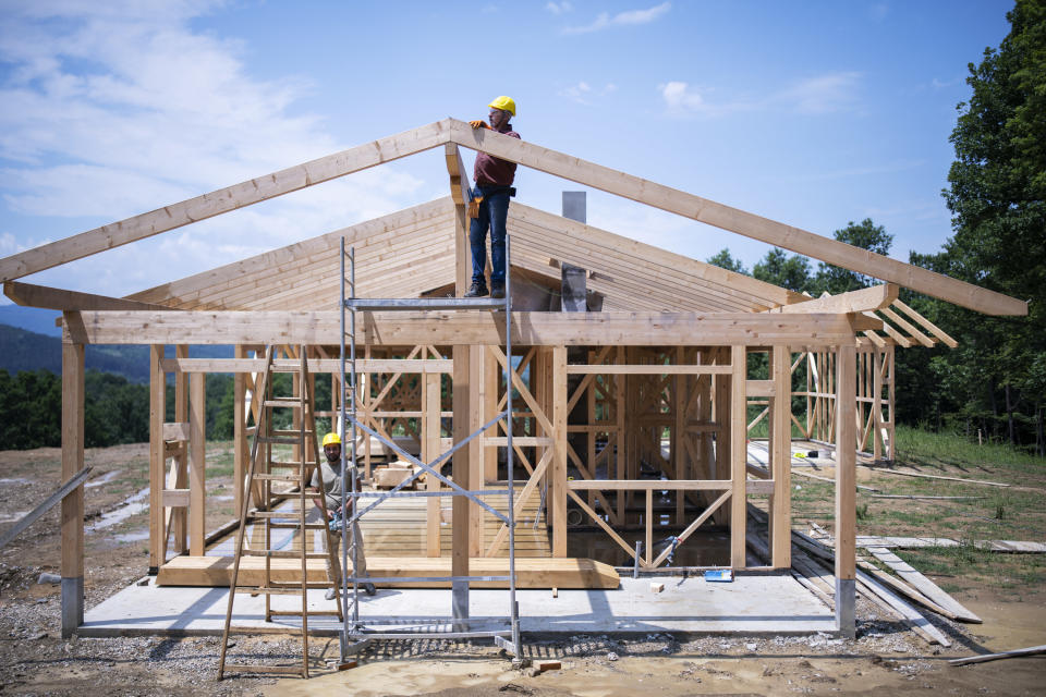 Construction workers building a house