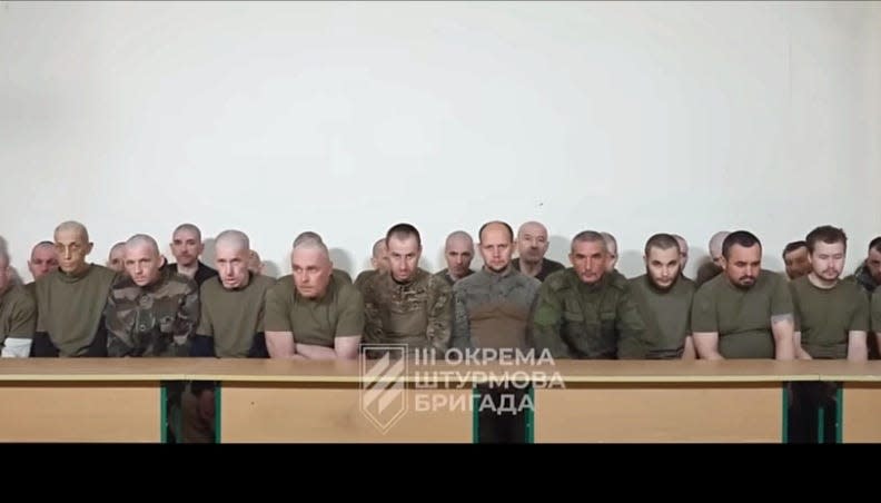 Russian soldiers lined up in a video.