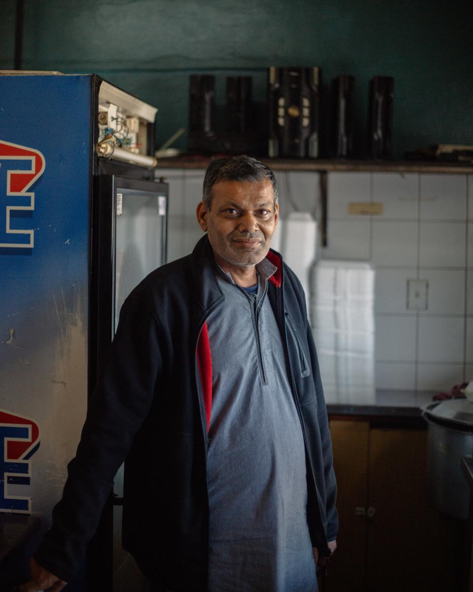 Aamir Shahzad standing in his restaurant.