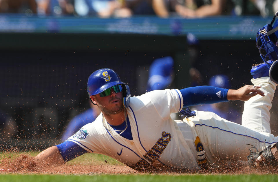 Kansas City Royals catcher Salvador Perez, right, tags out Seattle Mariners' Ty France at home plate as he tries to score on a double by Dominic Canzone during the sixth inning of a baseball game, Sunday, Aug. 27, 2023, in Seattle. (AP Photo/Lindsey Wasson)