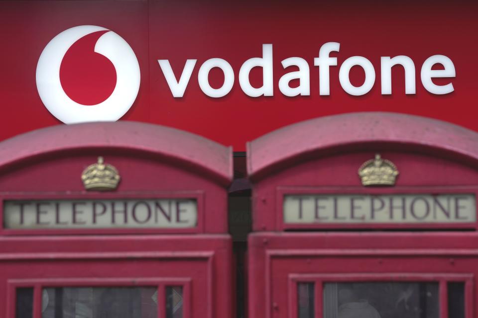 Phone boxes are placed in front of a Vodafone store in London, Wednesday, June 14, 2023. Vodafone and Three, which is owned by Hong Kong's CK Hutchison agreed Wednesday to merge their U.K. businesses in order to capitalize on the rollout of the next generation of wireless technology. (AP Photo/Kin Cheung)