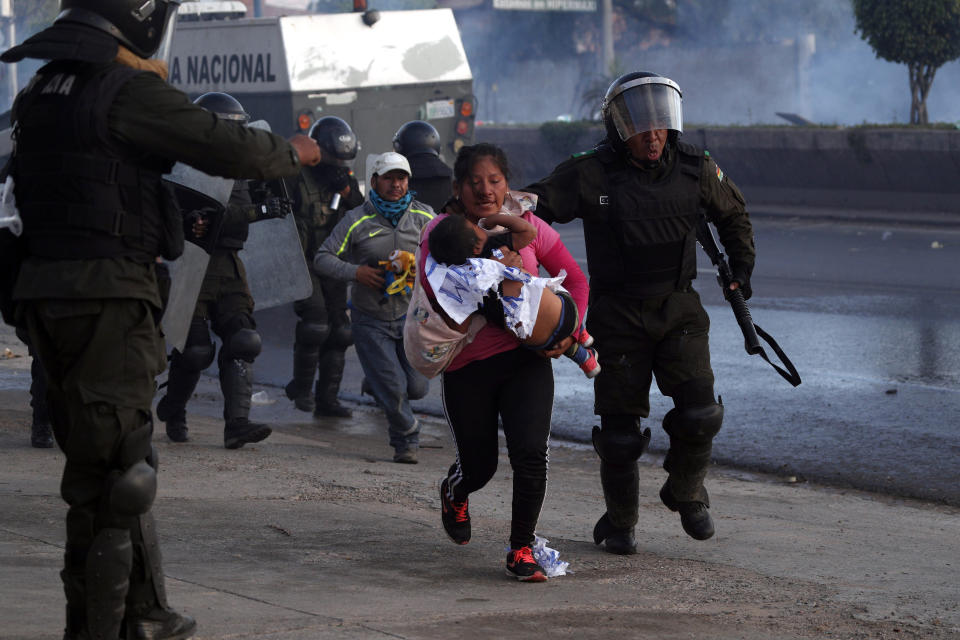 Police detain backers of former President Evo Morales on the outskirts of Cochabamba, Bolivia, Saturday, Nov. 16, 2019. Officials now say at least eight people died when Bolivian security forces fired on Morales supporters the day before, in Sacaba. The U.N. human rights chief says she's worried that Bolivia could "spin out of control" as the interim government tries to restore stability following the resignation of the former president in an election dispute. (AP Photo/Juan Karita)