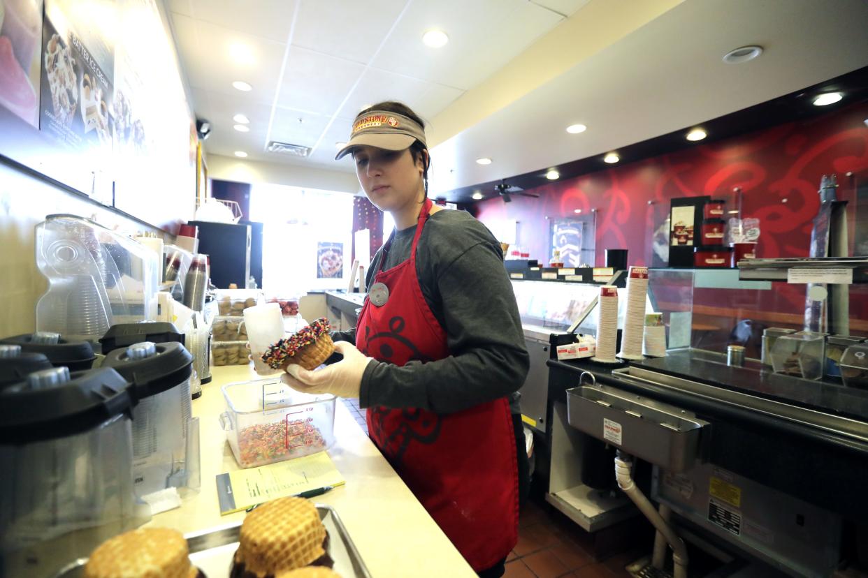 Assistant manager Allyson Jurgensen makes chocolate-covered waffle bowls with sprinkles at Cold Stone Creamery on Wednesday, January 25, 2023, in Appleton, Wis. The store, 3420 E. Calumet St., will be going through renovations.