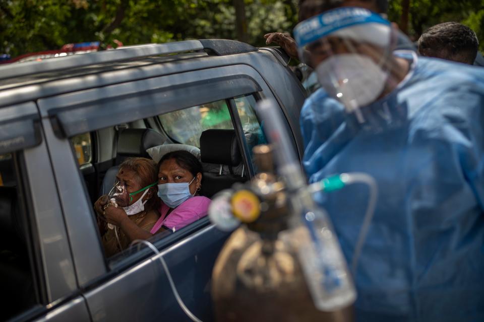 <p>A patient receives oxygen inside a car provided by a Gurdwara in New Delhi</p> (AP)