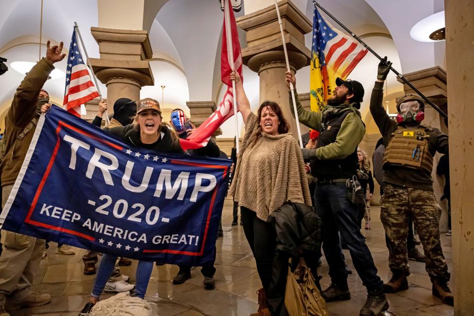 trump supporters wave flags and pose for photos after storming the capitol