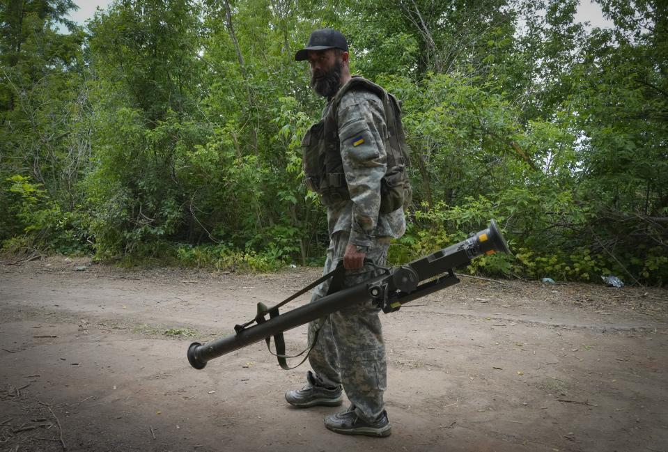 FILE - A Ukrainian soldier carries a U.S.-supplied Stinger as he goes along the road, in Ukraine's eastern Donetsk region, June 18, 2022. The deliveries of Western weapons have been crucial for Ukraine's efforts to fend off Russian attacks in the country's eastern industrial heartland of Donbas. (AP Photo/Efrem Lukatsky, File)