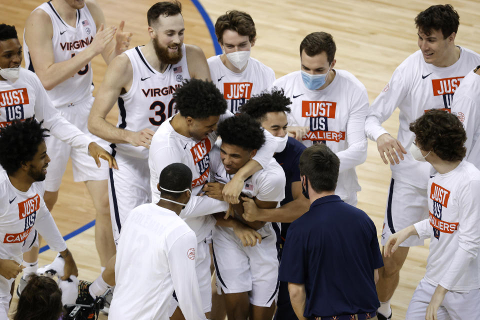 GREENSBORO, NORTH CAROLINA - MARCH 11: Reece Beekman #2 of the Virginia Cavaliers reacts with his team after hitting the game-winning three point basket as time expired on the clock during the second half of their quarterfinals game against the Syracuse Orange in the ACC Men's Basketball Tournament at Greensboro Coliseum on March 11, 2021 in Greensboro, North Carolina. (Photo by Jared C. Tilton/Getty Images)