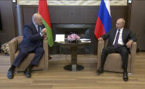 In this photo taken from video and released by Russian Presidential Press Service, Russian President Vladimir Putin, right, and Belarusian President Alexander Lukashenko talk during their meeting in the Bocharov Ruchei residence in the Black Sea resort of Sochi, Russia, Monday, Sept. 14, 2020. Belarus' authoritarian president is visiting Russia in a bid to secure more loans and political support as demonstrations against the extension of his 26-year rule enter their sixth week. Alexander Lukashenko's talks Monday with Russian President Vladimir Putin in the Black Sea resort of Sochi come a day after an estimated 150,000 flooded the streets of the Belarusian capital, demanding Lukashenko's resignation. (Russian Presidential Press Service via AP)