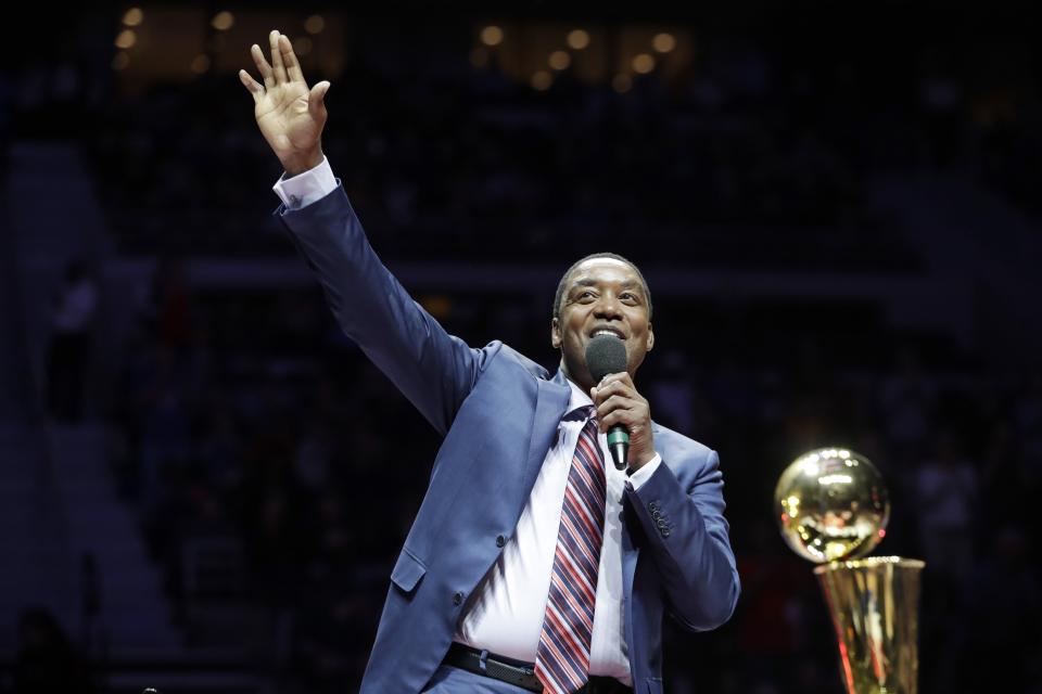 Former Detroit Pistons guard Isiah Thomas waves to the crowd during halftime of an NBA basketball game between the Detroit Pistons and the Los Angeles Lakers, Wednesday, Feb. 8, 2017, in Auburn Hills, Mich. Thomas was honored at halftime as part of the team's ongoing celebration of its years at The Palace. (AP Photo/Carlos Osorio)