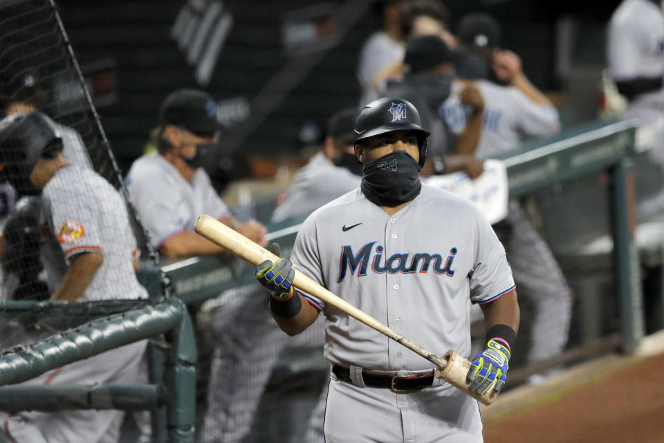 Miami Marlins' Jesus Aguilar wears a face mask to protect against COVID-19 as he stands at the on deck circle during the first inning of a baseball game against the Baltimore Orioles, Tuesday, Aug. 4, 2020, in Baltimore, Md. (AP Photo/Julio Cortez)