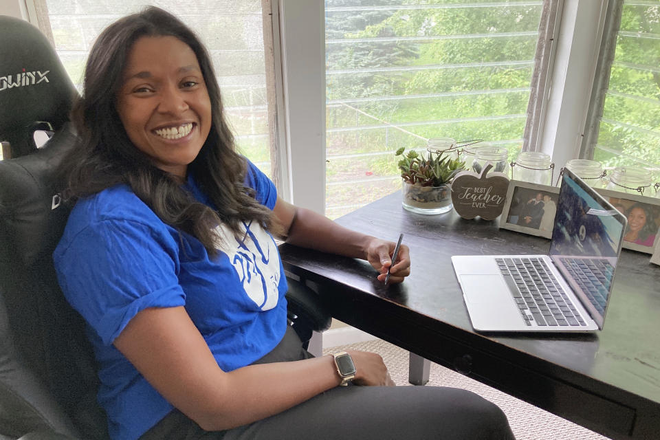 Lindsey West, a fifth-grade teacher at Clara Barton Community School in Minneapolis who identifies as Black and Indigenous, poses at her home in suburban Minneapolis on Friday, Aug. 19, 2022. A dispute has arisen over language in the new Minneapolis teachers contract that’s meant to protect teachers of color from layoffs. West said the seniority language is one piece of a bigger mission of improving education. (AP Photo/Steve Karnowski)