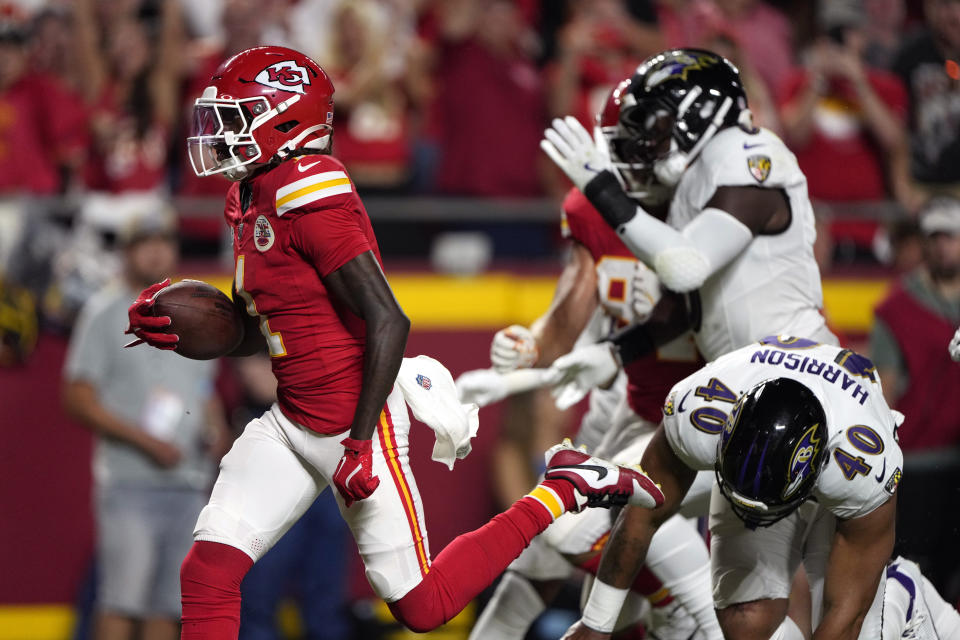 Kansas City Chiefs wide receiver Xavier Worthy (left) scores on the first drive of the season. (AP Photo/Charlie Riedel)