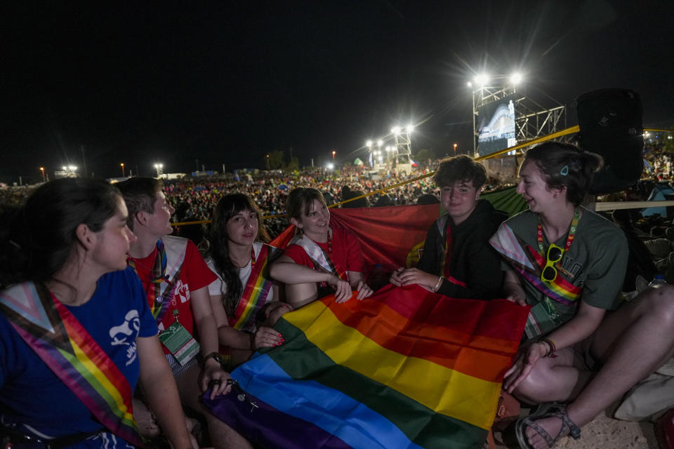 Representatives of Dignity USA, a group of LGBTQ+ Catholics, attend a vigil with Pope Francis at Parque Tejo in Lisbon the day before the 37th World Youth Day, Saturday, Aug. 5, 2023. After an incident of intolerance against LGBTQ+ Catholics attending World Youth Day preparations that took on greater weight Friday, the Socialist government issued a statement demanding that pilgrims respect one another. (AP Photo/Ana Brigida)