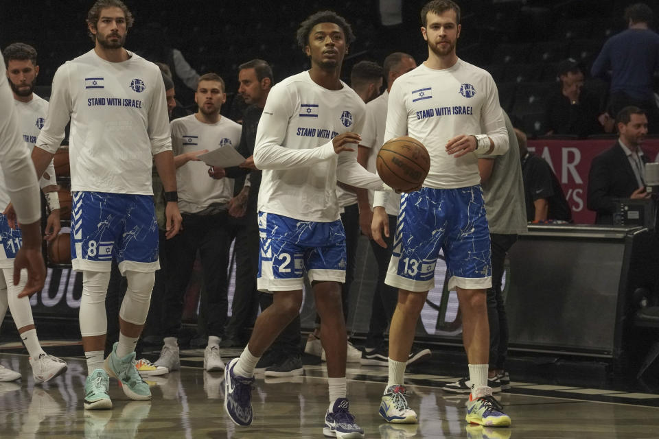 Members of Israel's Maccabi Ra'anana basketball team wear shirts in support of Israel during warmups before a preseason NBA basketball game against the Brooklyn Nets, Thursday, Oct. 12, 2023, in New York. (AP Photo/Bebeto Matthews)