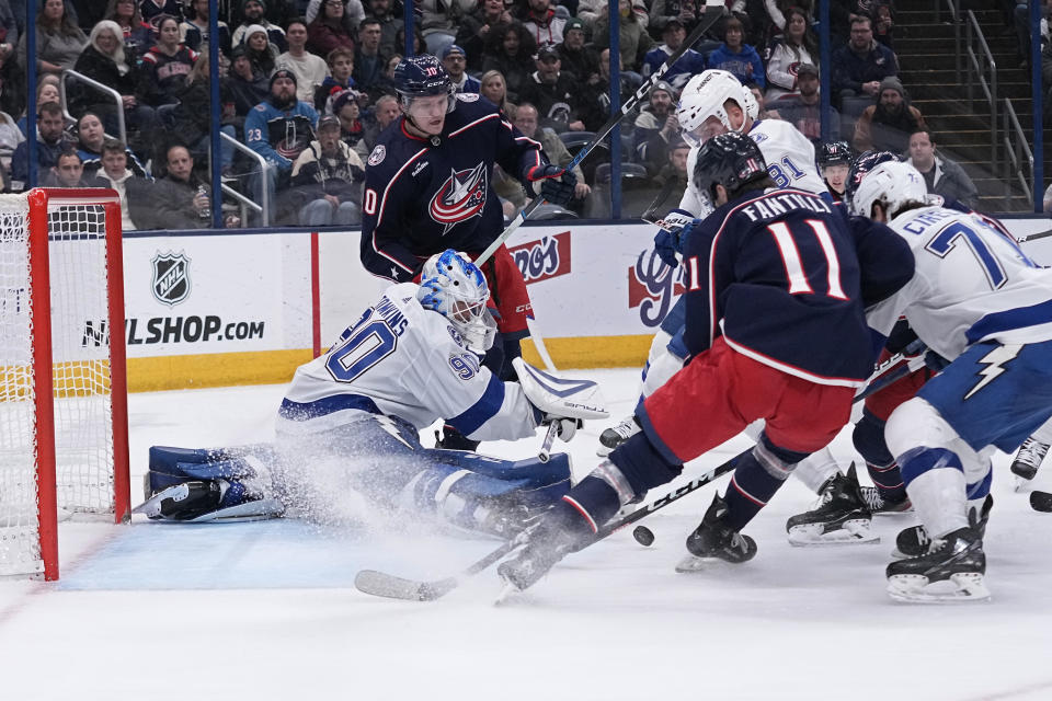 Tampa Bay Lightning goaltender Matt Tomkins (90) blocks a shot by Columbus Blue Jackets center Adam Fantilli (11) in the second period of an NHL hockey game Thursday, Nov. 2, 2023, in Columbus, Ohio. (AP Photo/Sue Ogrocki)