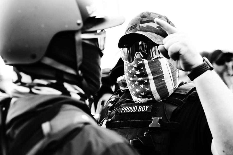 A member of the Proud Boys, a far-right extremist group with a history of violent confrontations, gestures toward a counter protester as right-wing demonstrators rally in September in Portland.