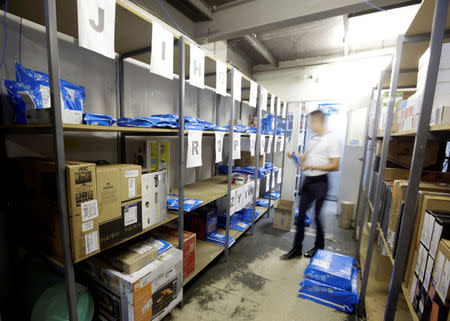 An employee prepares merchandise sold via eCommerce to be delivered to customers at retail chain Magazine Luiza S.A. store in Sao Paulo, Brazil April 21, 2018. Picture taken April 21, 2018. REUTERS/Paulo Whitaker