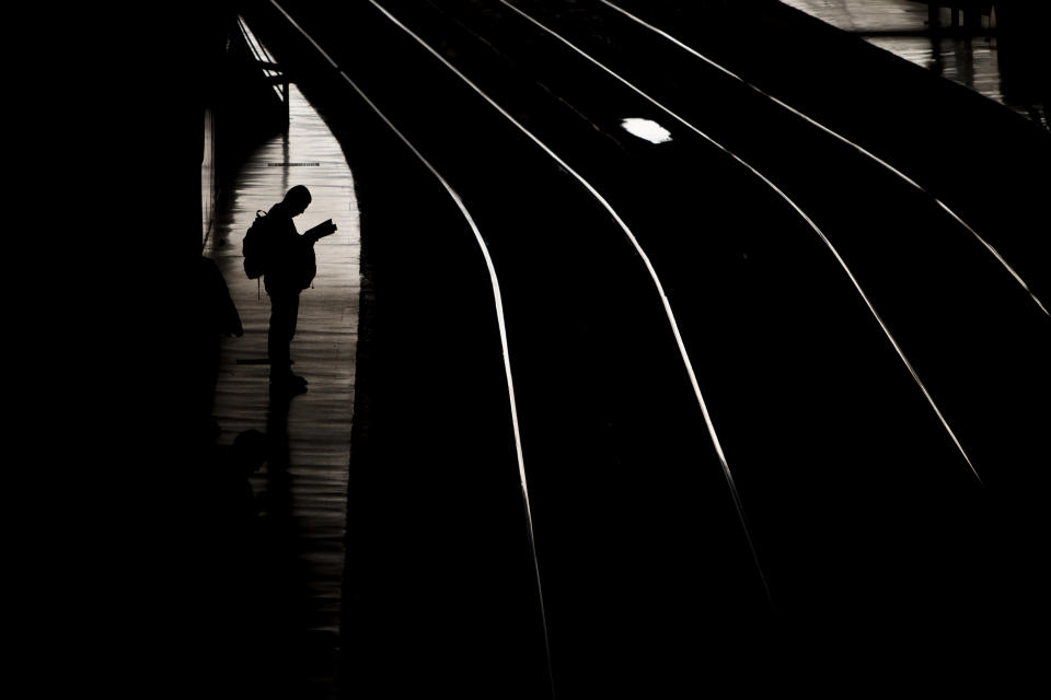 A man waits for the train in Atocha train station in Madrid, Spain, Tuesday, March 11, 2014, during the remembrance of those killed and injured in the Madrid train bombings marking the 10th anniversary of Europe's worst Islamic terror attack. The attackers targeted four commuter trains with 10 shrapnel-filled bombs concealed in backpacks during morning rush hour on March 11, 2004. (AP Photo/Andres Kudacki)