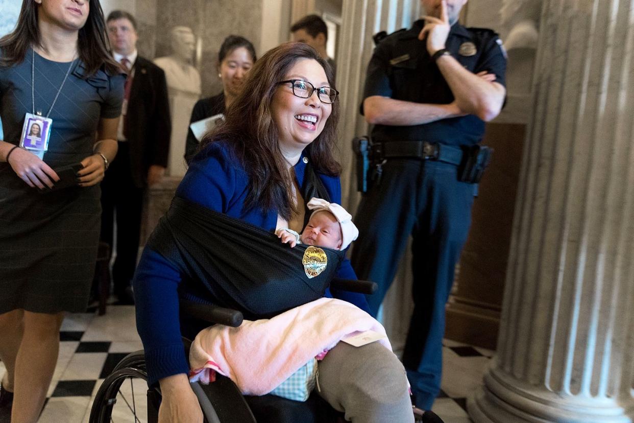 tammy duckworth leaves the senate chamber after a vote with her newborn baby daughter maile pearl bowlsbey at the us capitol