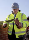 Britain's Prime Minister Boris Johnson poses for a photo during a visit to Barratt Homes development site Great Oldbury, in Gloucestershire, England, Monday, April 19, 2021, to launch the government's 95 percent mortgage guarantee scheme. (Jonathan Buckmaster, Pool Photo via AP)