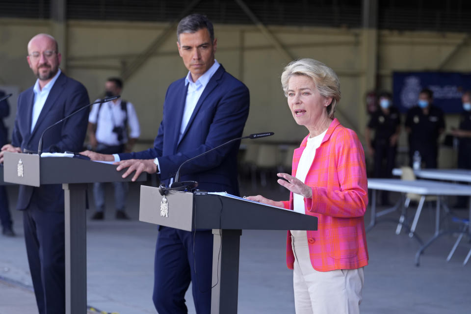 EU Commission president Ursula von der Leyen, right, speaks alongside EU Council President Charles Michel, left, and Spain's Prime Minister Pedro Sanchez during a news conference at the Torrejon military airbase in Madrid, Spain, Saturday, Aug. 21, 2021. Top European Union officials visited a Spanish military airport being used as a hub to receive Afghans flown out of Kabul before they are distributed to other countries in the bloc. (AP Photo/Paul White)