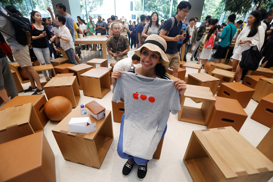 <p>A visitor poses with a souvenir t-shirt given away at the city-state’s first Apple Store on its opening day at Orchard Road, Singapore May 27, 2017. (Photo: Edgar Su/Reuters) </p>