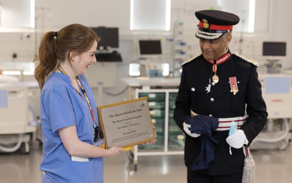 Nurse Charlie Mort and Sir Kenneth Olisa, Lord-Lieutenant of Greater London, unveil the plaque to mark the hospital's Covid unit officially open - Ralph Hodgson