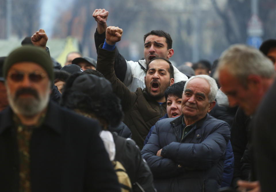 Opposition demonstrators shout slogans during a rally to pressure Armenian Prime Minister Nikol Pashinyan to resign in Yerevan, Armenia, Monday, March 1, 2021. Amid escalating political tensions in Armenia, supporters of the country's embattled prime minister and the opposition are staging massive rival rallies in the capital of Yerevan. Prime Minister Nikol Pashinyan has faced opposition demands to resign since he signed a peace deal in November that ended six weeks of intense fighting with Azerbaijan over the Nagorno-Karabakh region. (Hrant Khachatryan/PAN Photo via AP)