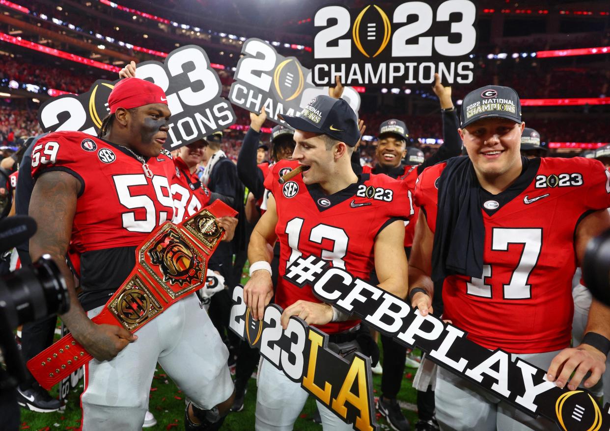 Georgia Bulldogs players celebrate winning the 2023 College Football Playoff National Championship.