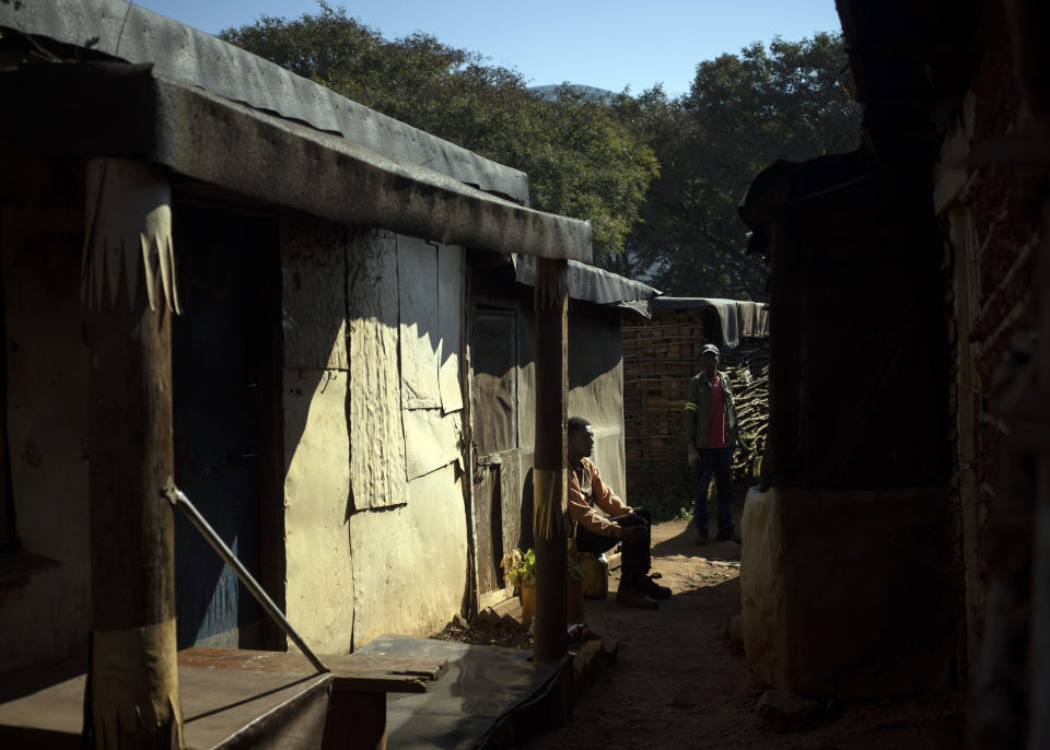 A man sits on a chair in an informal settlement in Ngodwana, South Africa, Thursday, July 30, 2020. Across Africa and around the world, the COVID-19 pandemic has disrupted the supply of antiretroviral drugs to many of the more than 24 million people who take them, endangering their lives. An estimated 7.7 million people in South Africa are HIV positive, the largest number in the world, and 62% of them take the antiretroviral drugs that suppress the virus and prevent transmission. (AP Photo/Bram Janssen)