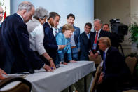 Canada's Prime Minister Justin Trudeau and G7 leaders Britain's Prime Minister Theresa May, France's President Emmanuel Macron, Germany's Chancellor Angela Merkel, and U.S. President Donald Trump discuss the joint statement following a breakfast meeting on the second day of the G7 meeting in Charlevoix city of La Malbaie, Quebec, Canada, June 9, 2018. Adam Scotti/Prime Minister's Office/Handout via REUTERS