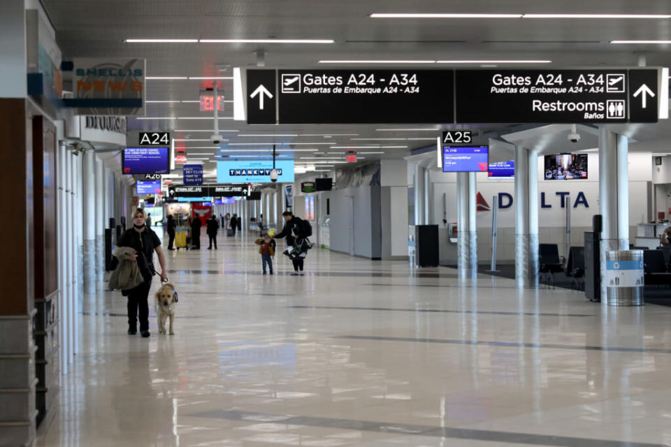 Travelers walk through terminal A at Hartsfield-Jackson Atlanta International Airport on April 20, 2020, in Atlanta. (Photo by Rob Carr/Getty Images)