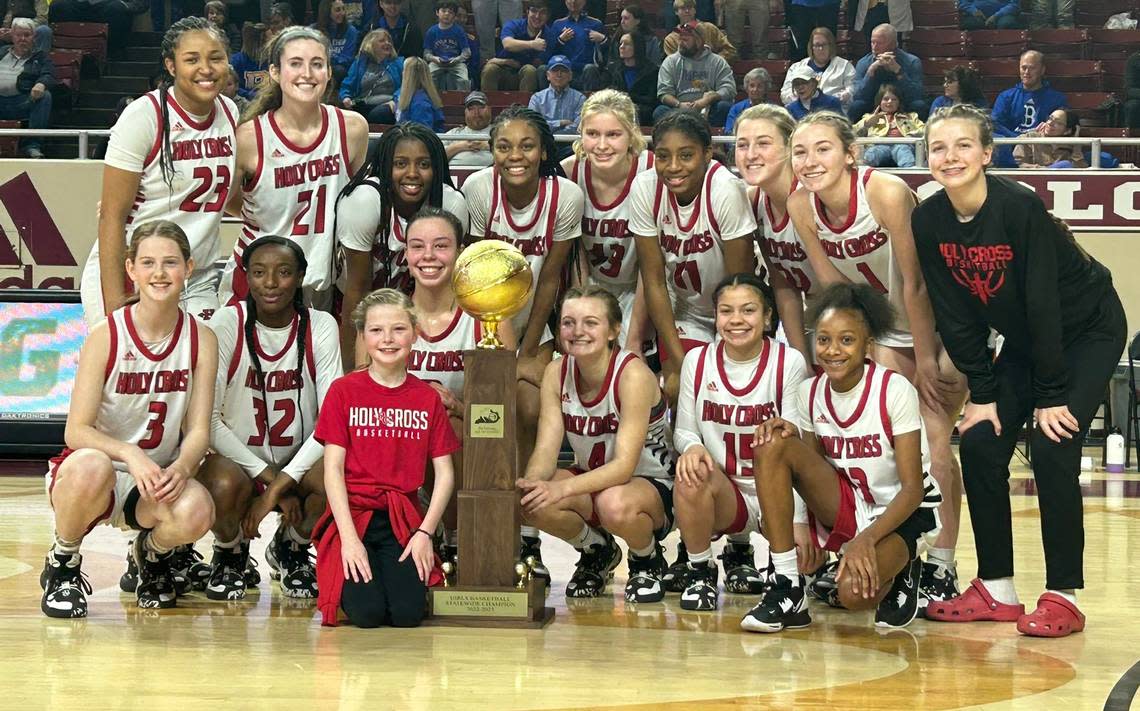 Covington Holy Cross’s girls basketball team celebrated with their All “A” Classic trophy after defeating Bethlehem 65-61 in Sunday’s championship game at Eastern Kentucky University’s Baptist Health Arena in Richmond.